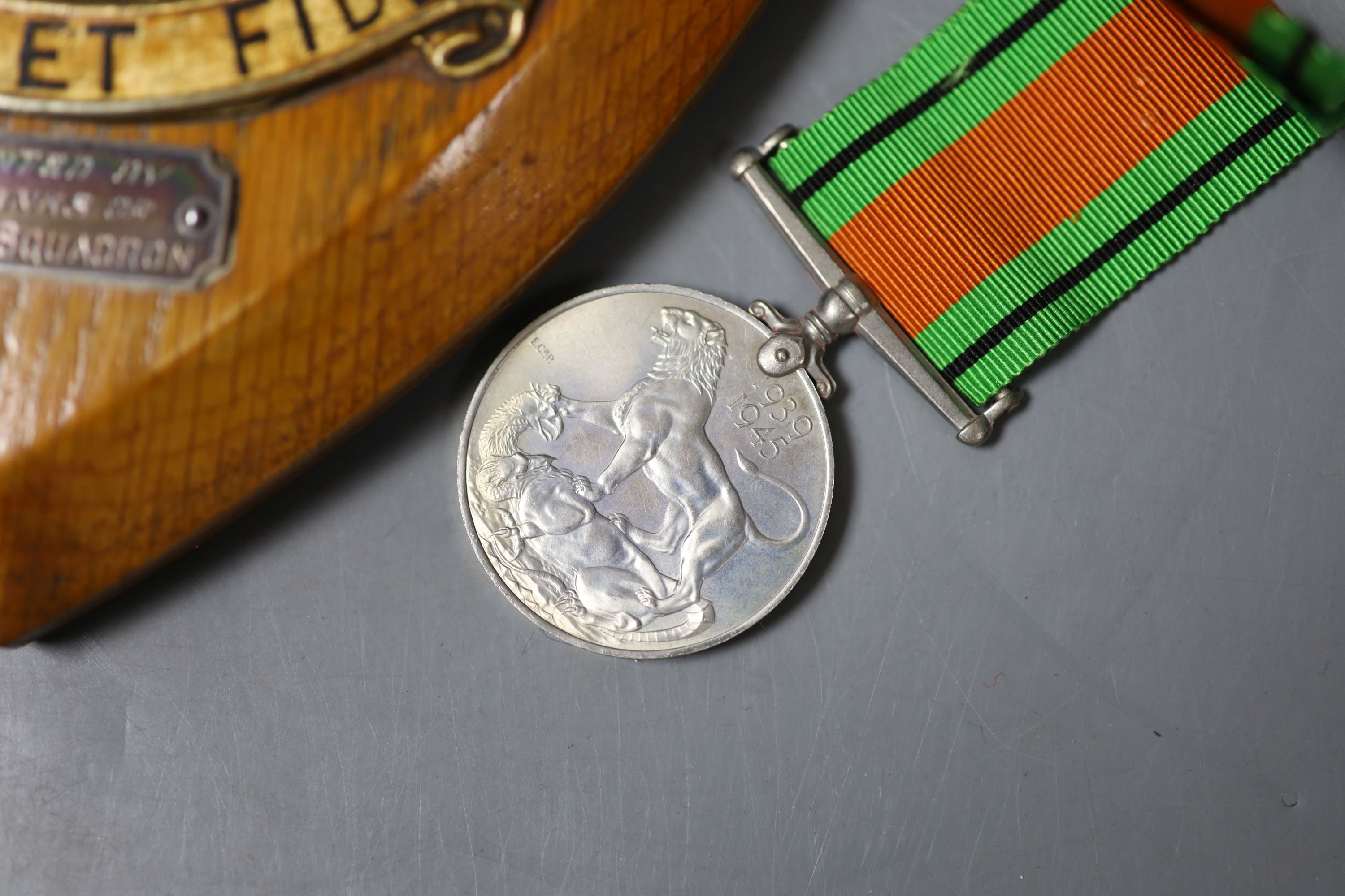 A group of three medals to Flight Sergeant H V Walder RAF 329595 including a George V RAF long service and good conduct medal and an RAF plaque, presented by all ranks of no.18 (B) squadron